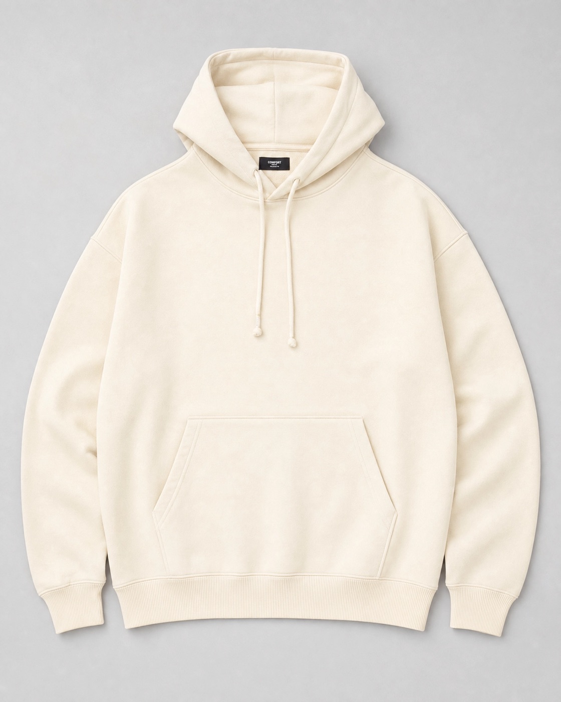 Flat-lay photograph of a cream oversized hoodie